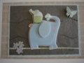 blue spraying elephant with bird on back